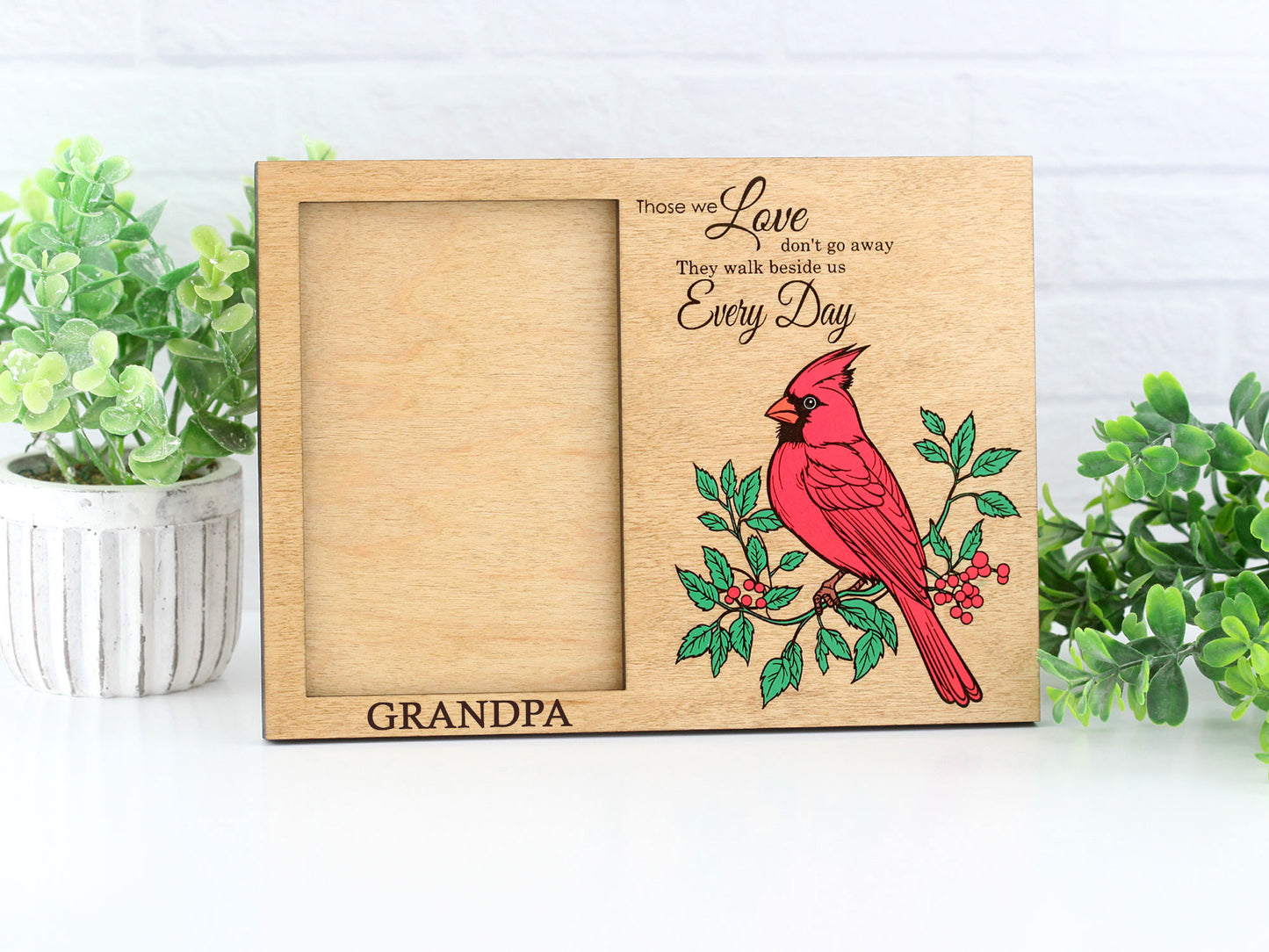 Wooden picture frame with a red cardinal design and personalized text on a white background.