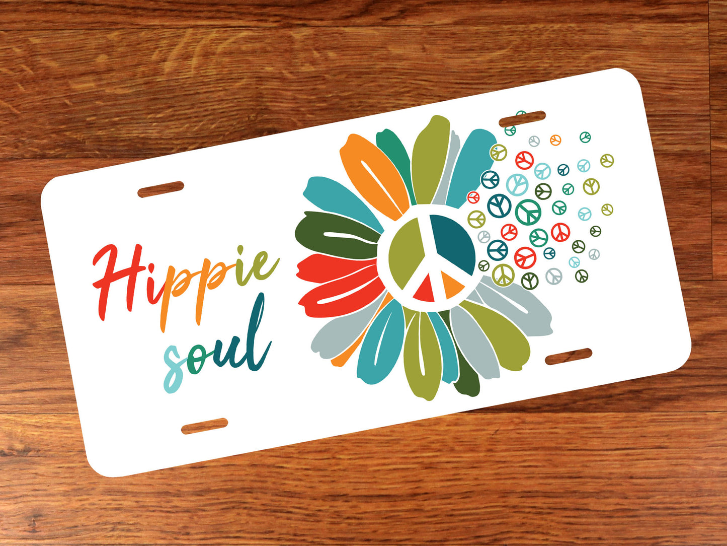 Colorful license plate with a peace symbol and 'Hippie soul' text on a wooden surface