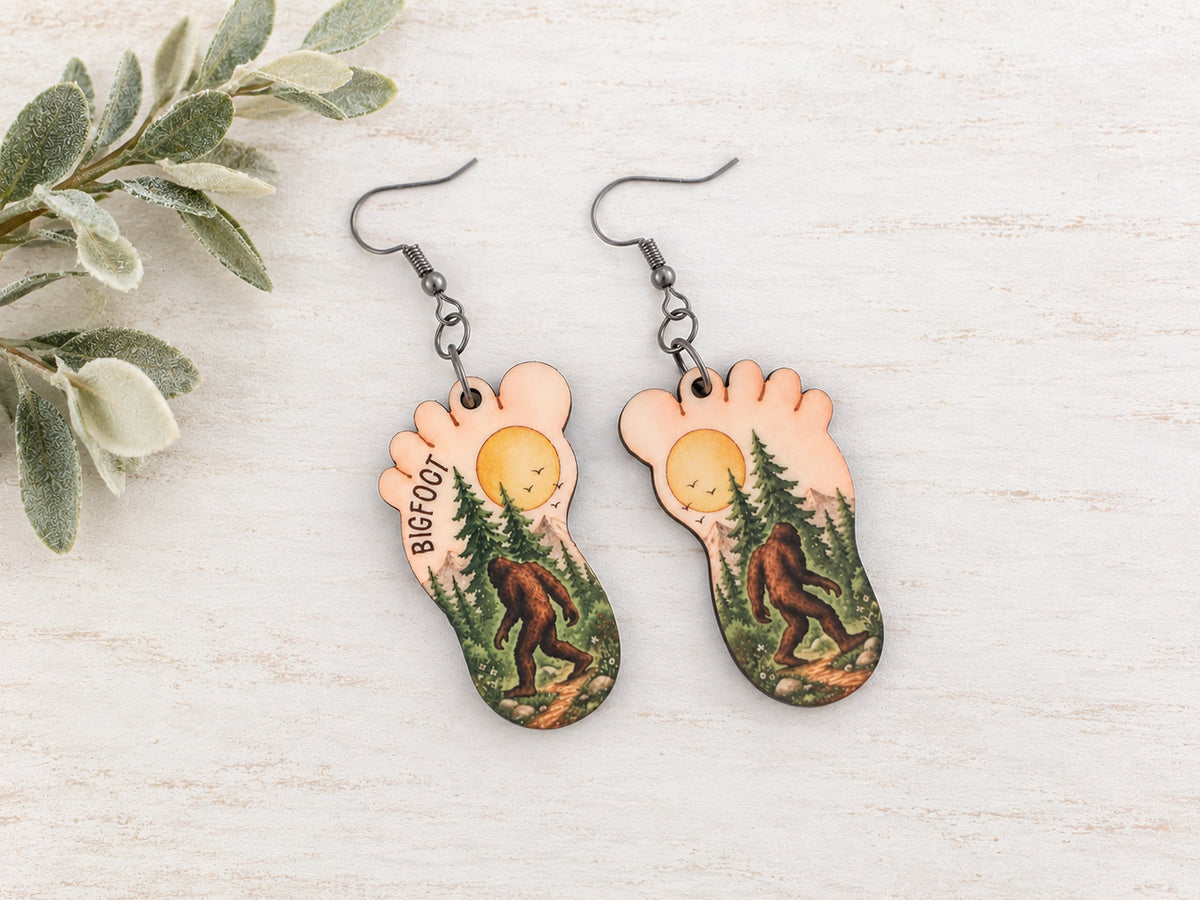 Bigfoot earrings with forest scene