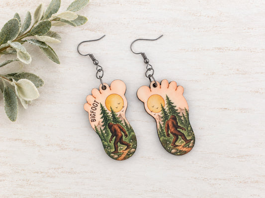 Bigfoot earrings with forest scene