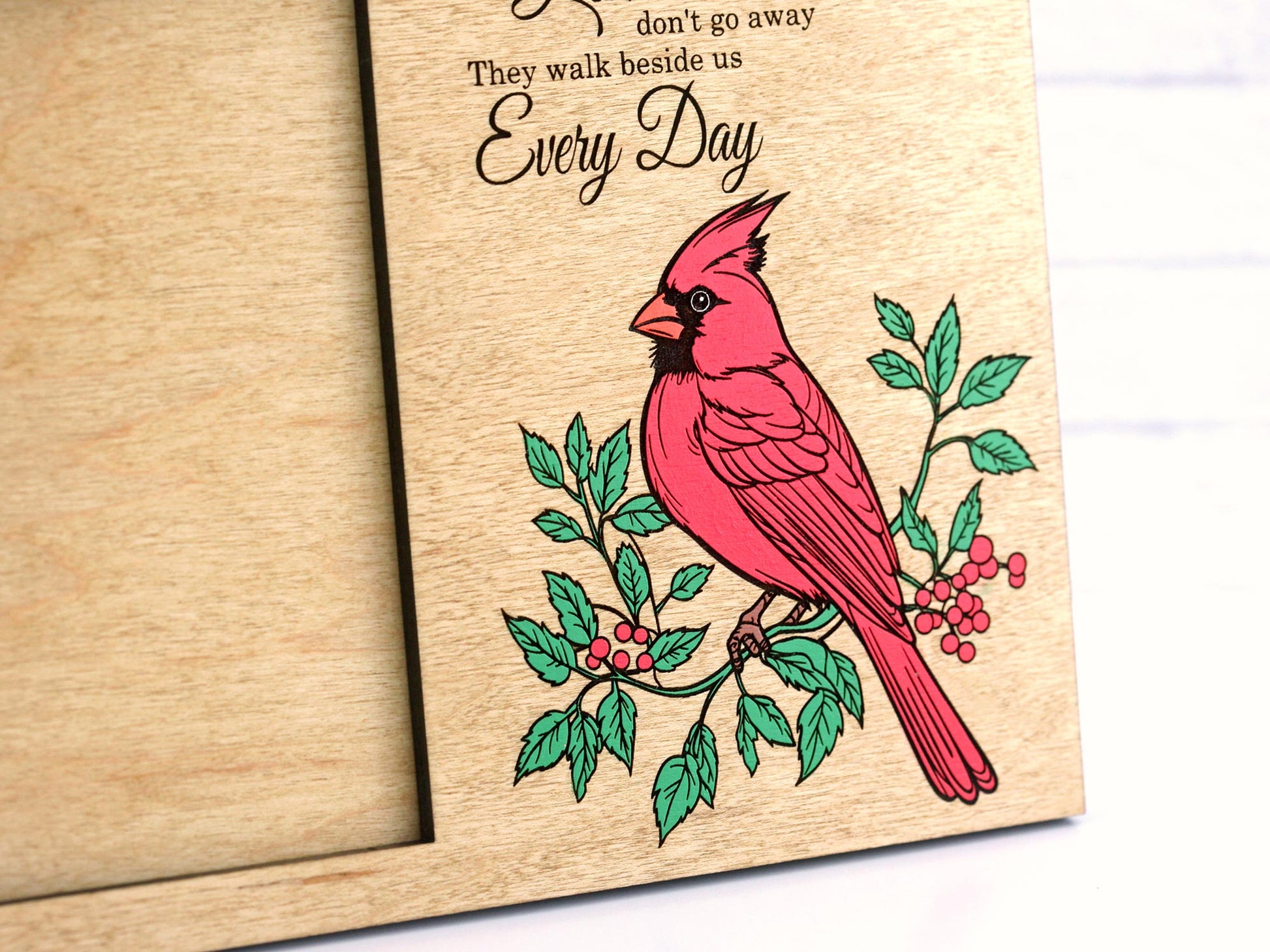 Wooden photo frame with a red cardinal bird illustration and text on a white background
