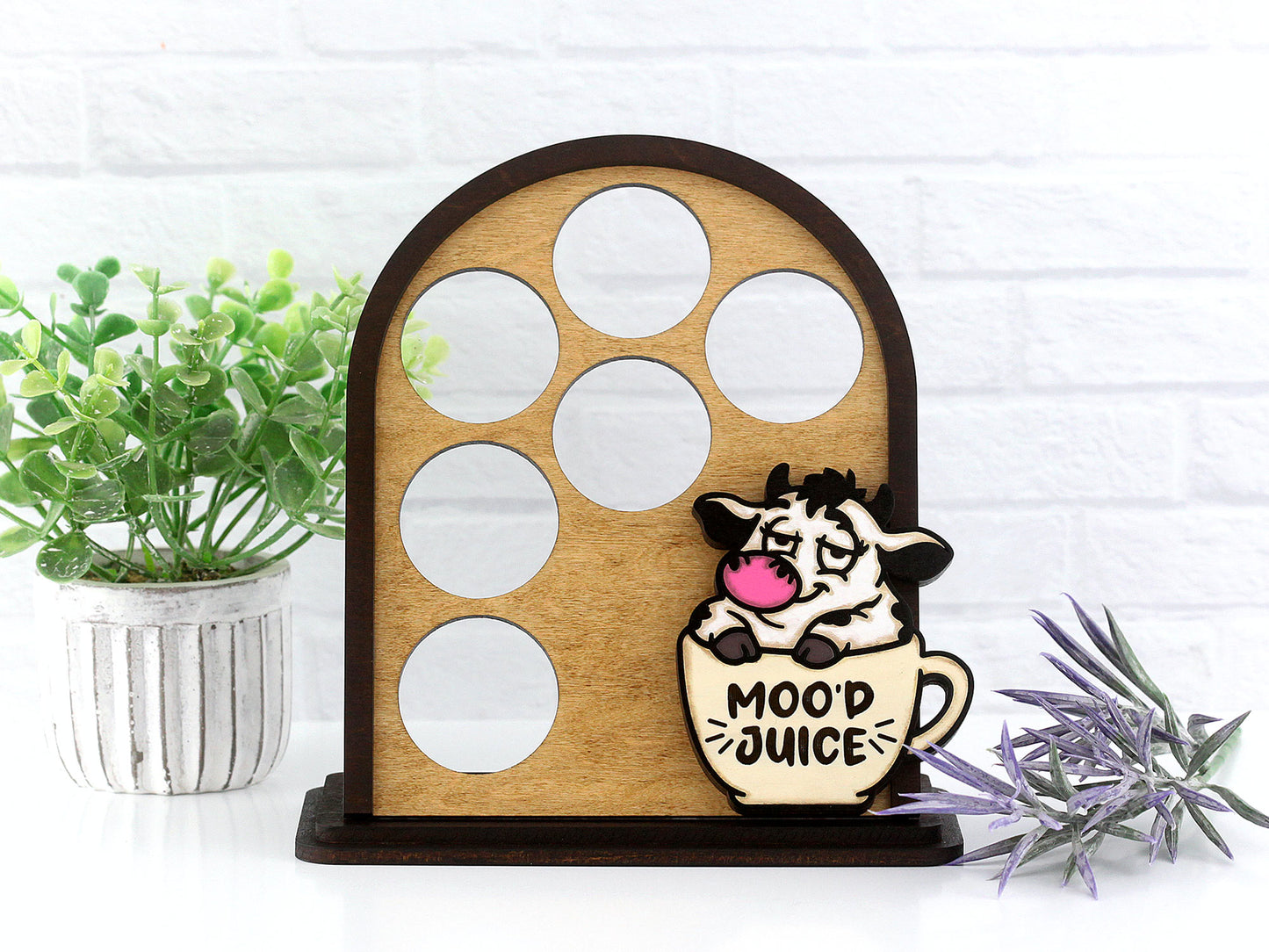 Wooden coffee pod holder with a decorative cow figure labeled 'Mood Juice' on a white background.