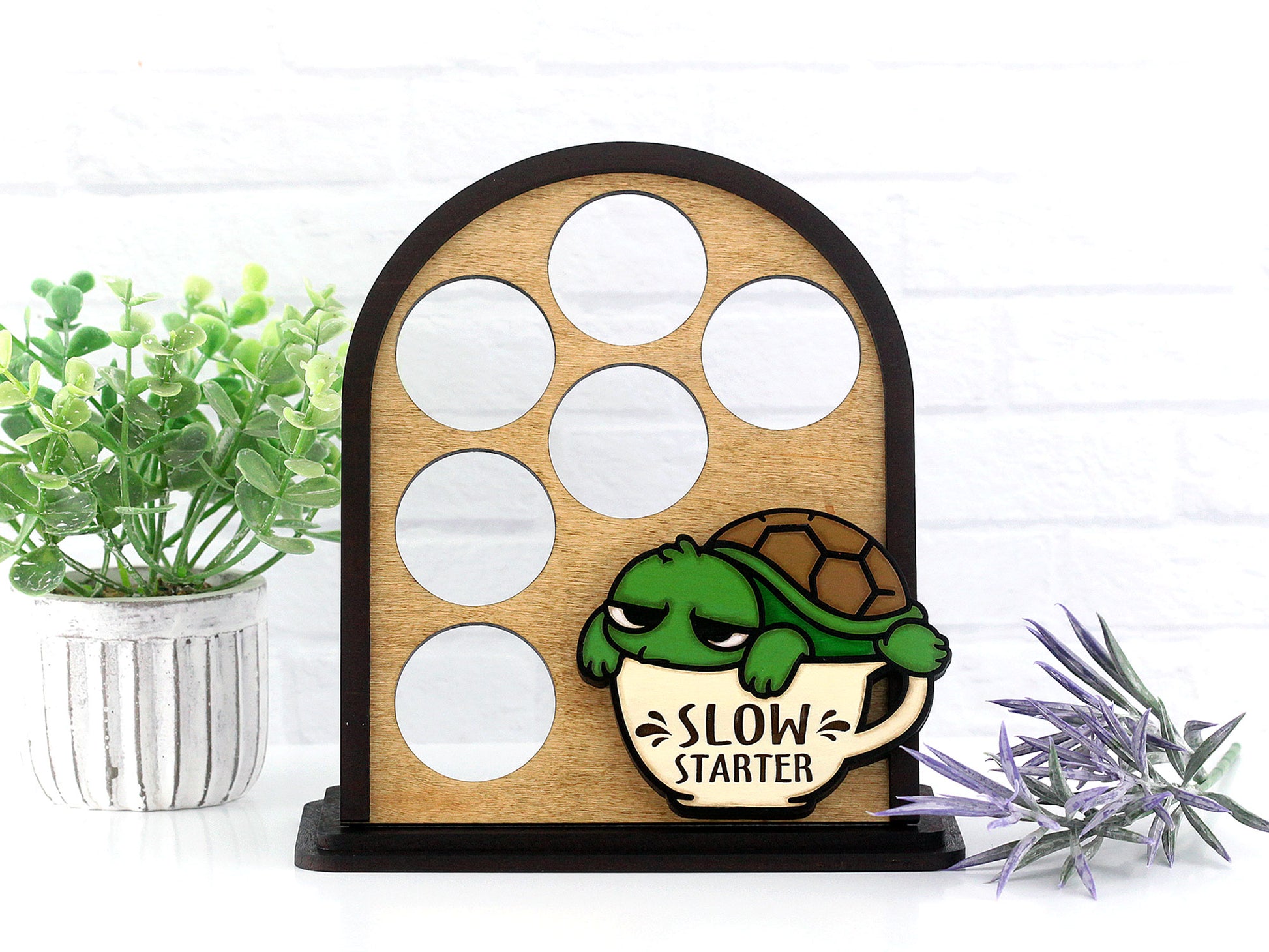 Wooden turtle-themed coffee pod holder with 'Slow Starter' design on a white background