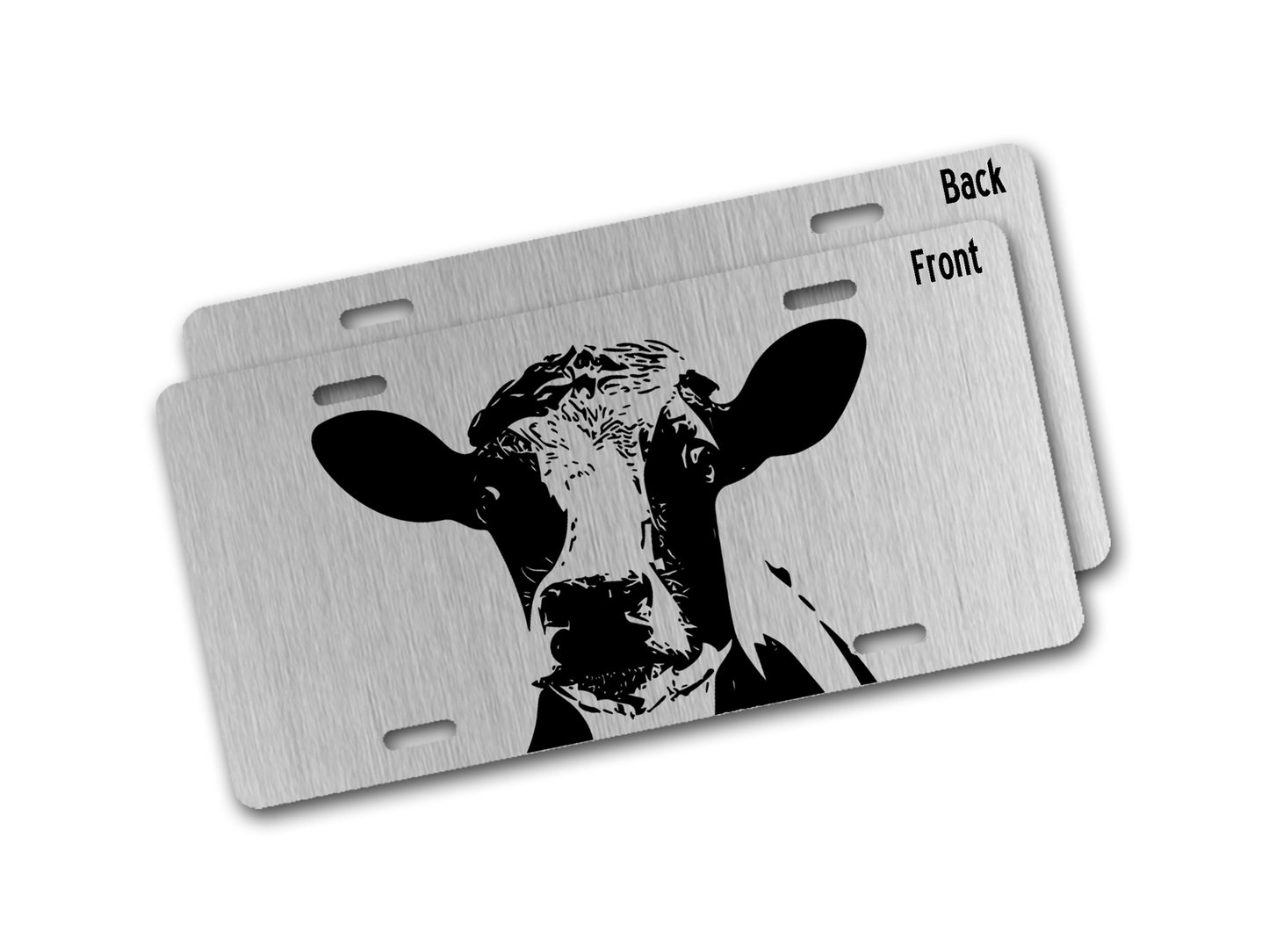 Metallic license plate with cow design on a white background