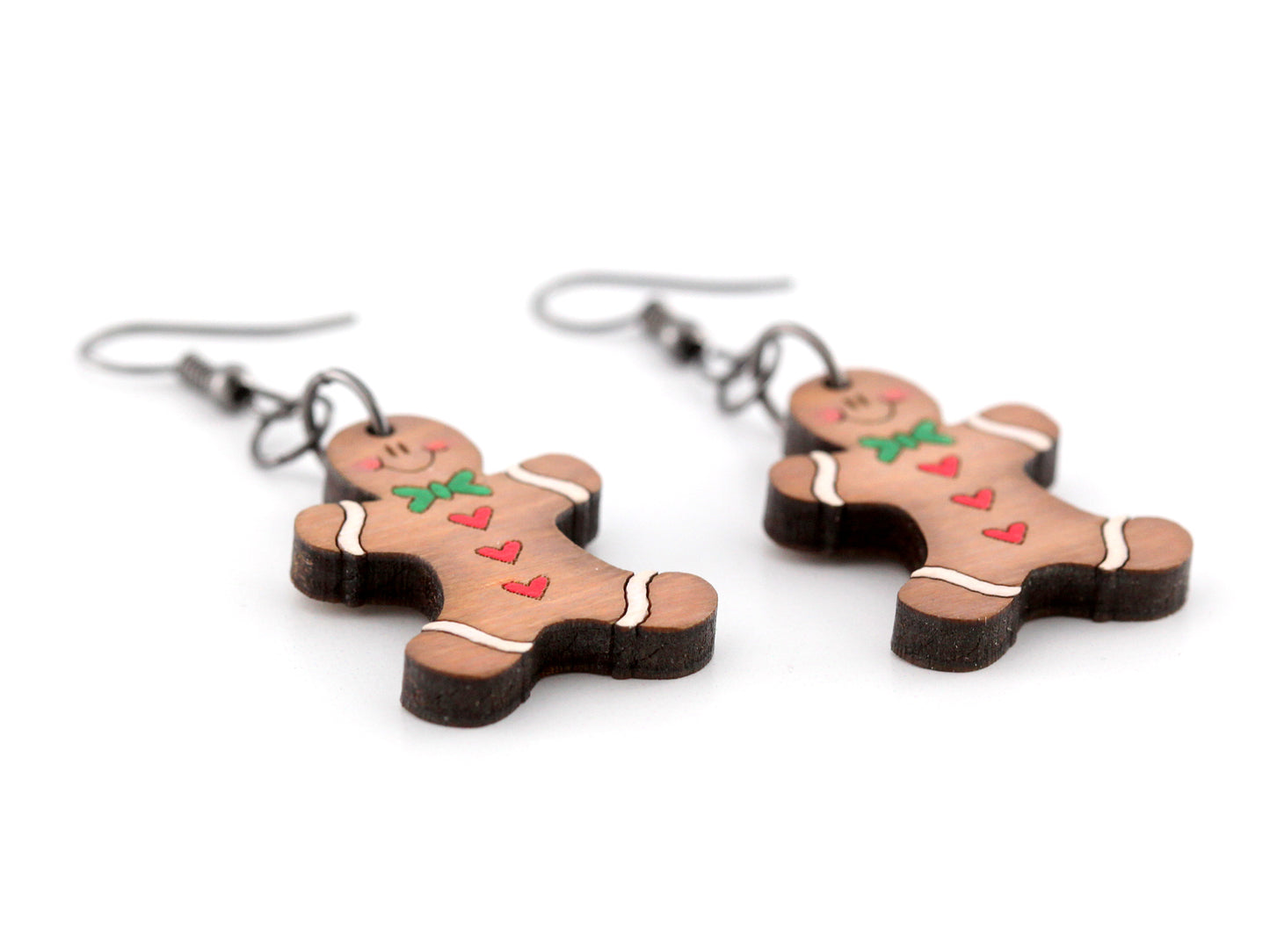 Hand painted gingerbread man earrings on a white background