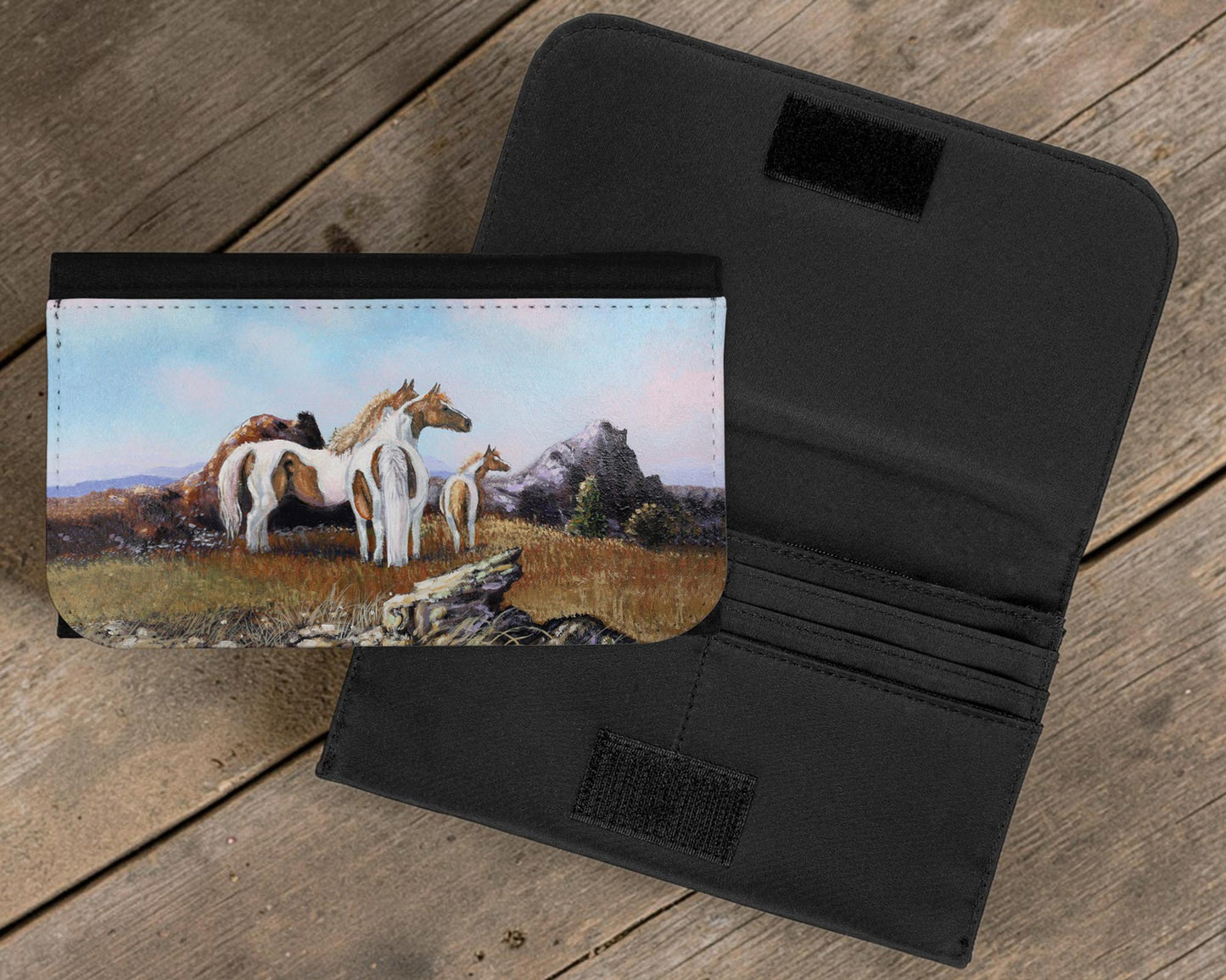 Black wallet with horse painting on a wooden surface