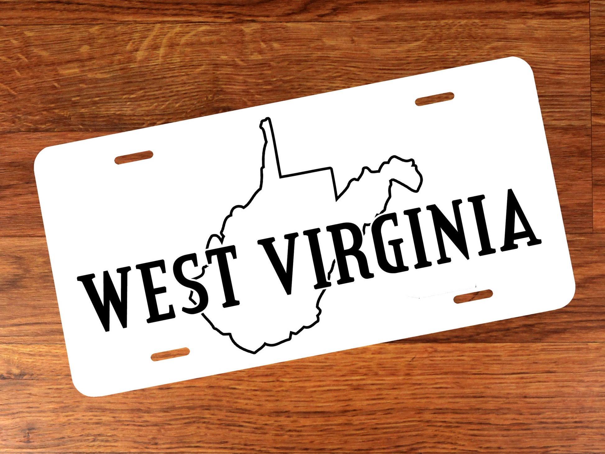 White license plate with black 'West Virginia' text and state outline